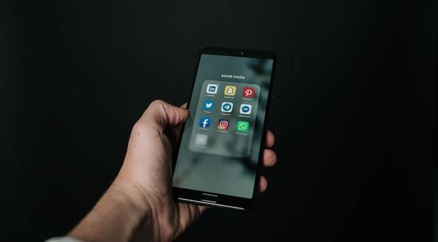 photo-of-hand-holding-a-black-smartphone-2818118.jpg