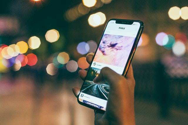 bokeh-photography-of-person-holding-turned-on-iphone-1440727.jpg