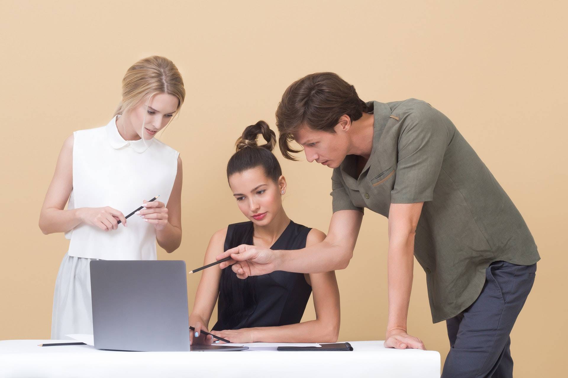 two-woman-and-one-man-looking-at-the-laptop-1036641.jpg